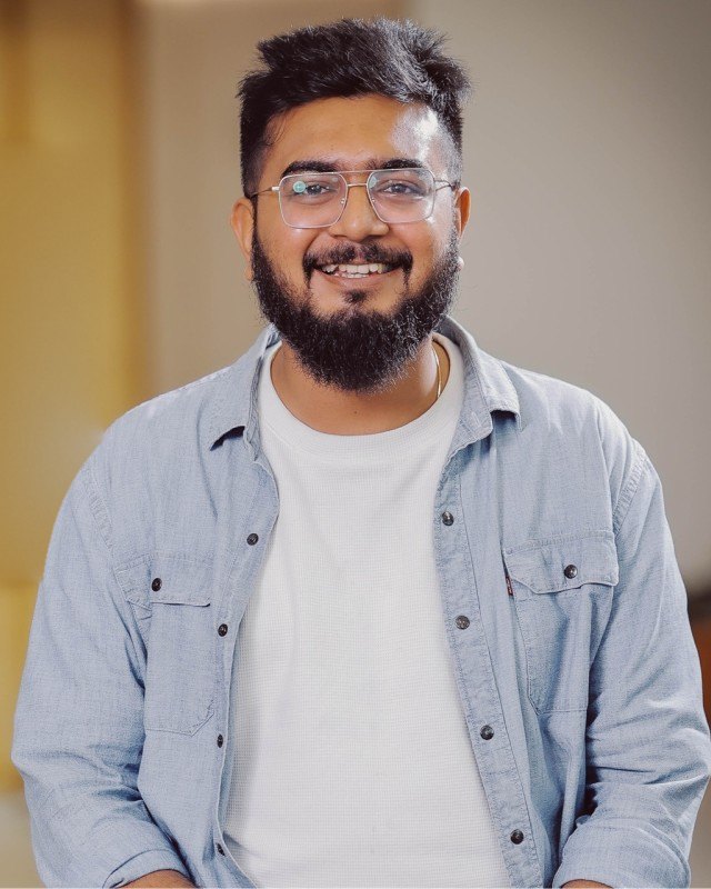Vikrant Deshmukh, smiling, in a light denim shirt